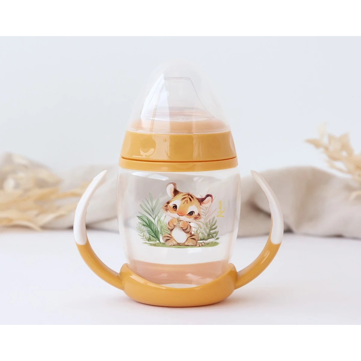 KIOKIDS 6336. TAZA DE APRENDIZAJE TIGRE CON ASAS PARA BEBÉ COLOR MOSTAZA